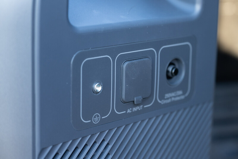 Close-up of control panel buttons on electronic device including power, AC input, and camera icon ports.