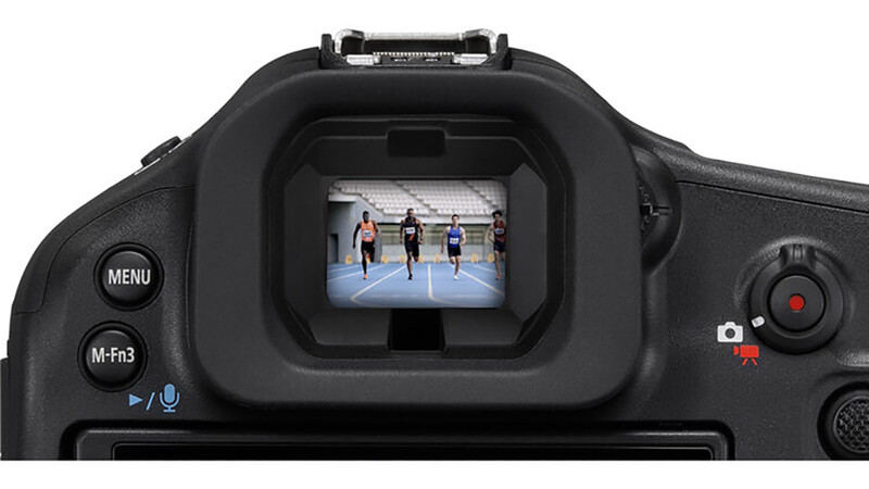 Camera viewfinder display showing three athletes on an indoor track during live video recording.