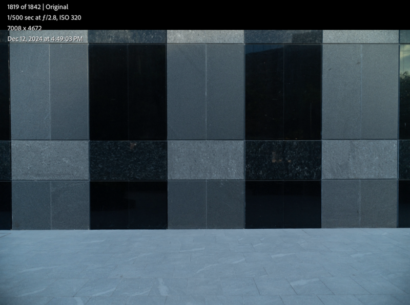 Color checker chart with gray and black squares displaying tonal and color accuracy in neutral lighting.