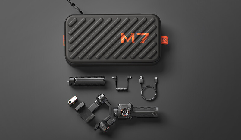 Flat lay of M7 gimbal stabilizer with carrying case and accessories on gray background.