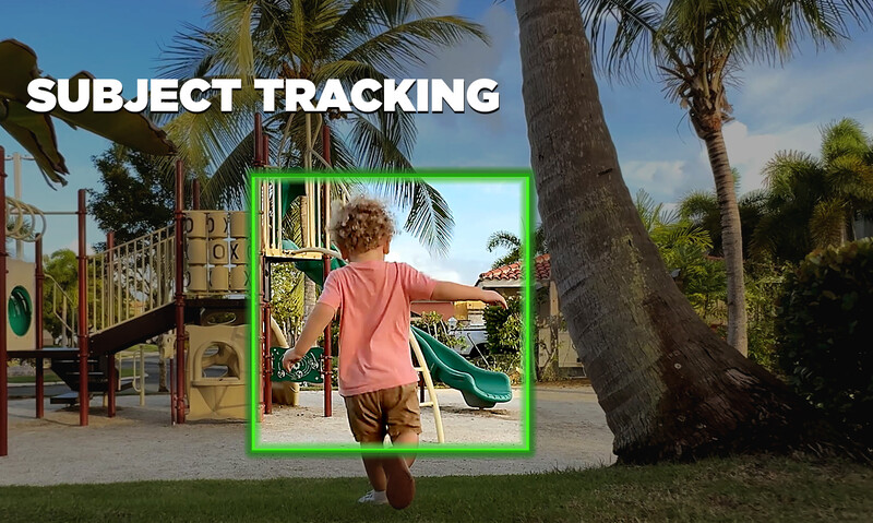 Child in pink shirt running toward playground with green subject tracking box overlaid around figure.