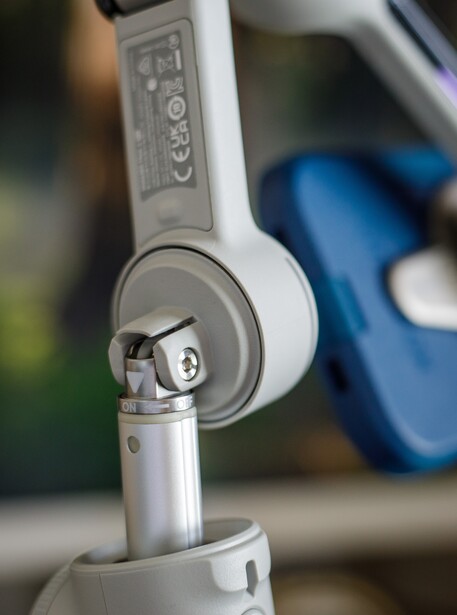 Close-up of white over-ear headphones with visible ear cup and headband detail.