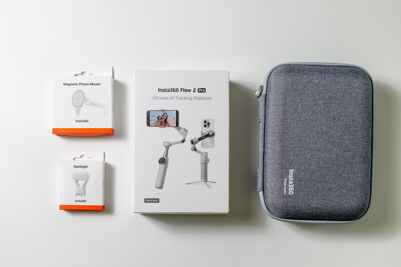 Insta360 Flow 2 gimbal with accessories and carrying case laid out flat.
