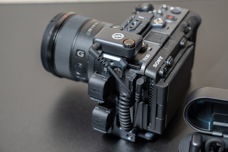 Sony FX30 cinema camera with attached lens on neutral gray surface.