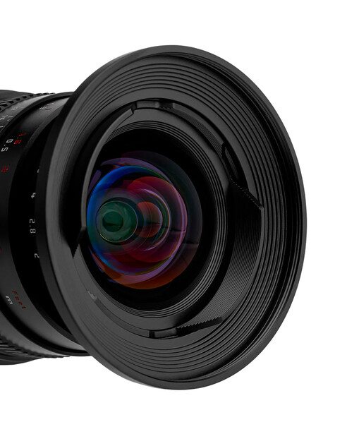 Close-up view of a wide-angle camera lens with multicoated glass elements visible through the open front.