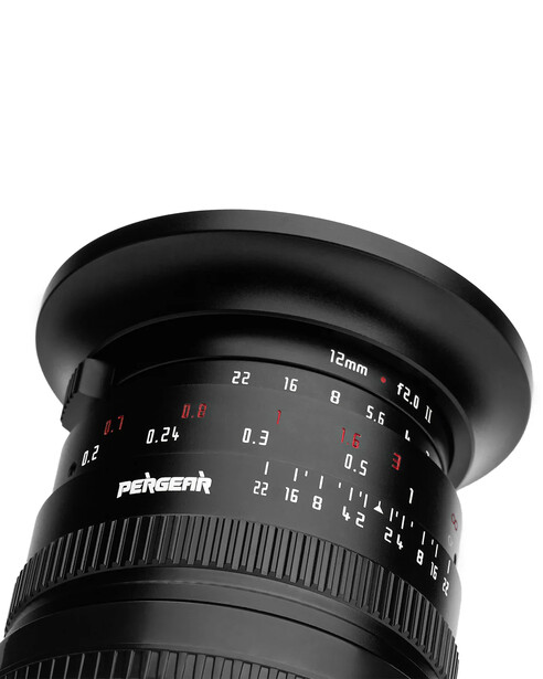 Close-up of a wide-angle lens showing aperture ring, focal length markings, and depth of field scale against black background.