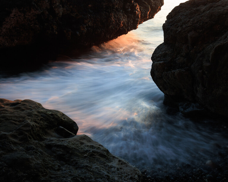 Waves rushing in between rocks