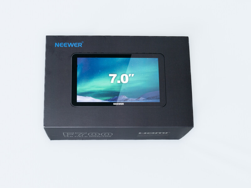 Neewer 7-inch monitor in black retail packaging with display window showing the device's screen.