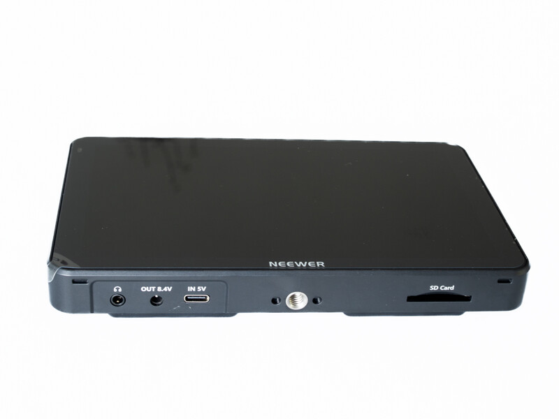 Neewer portable external recorder with black top panel and gray base, showing audio inputs, outputs, and SD card slot.