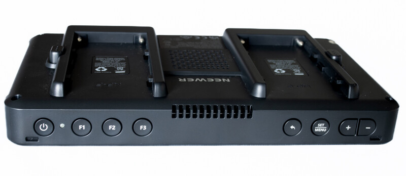 Dual battery charging dock with two vertical battery slots, power button, function keys, and control buttons on a dark gray base.