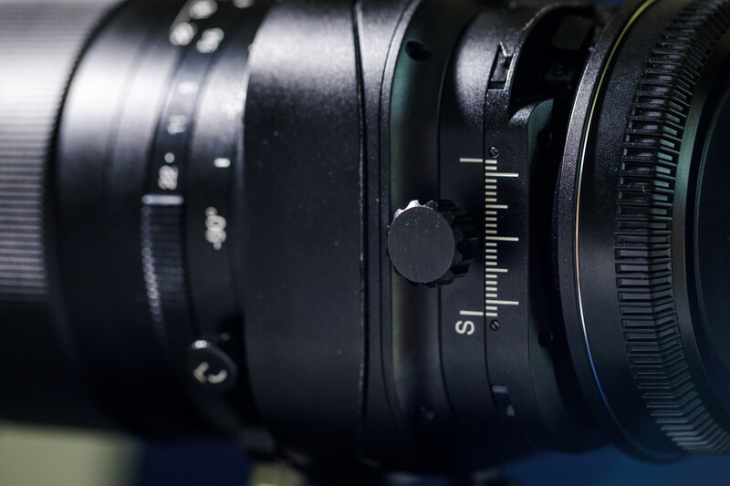 Close-up of vintage rangefinder camera lens assembly with focus ring and distance scale markings.