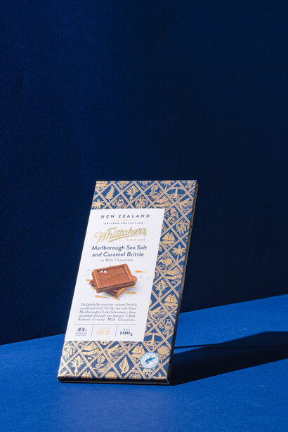 Product packaging with geometric pattern displayed at an angle against dark blue background with blue accent stripe.