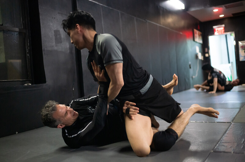Students training jiu jitsu