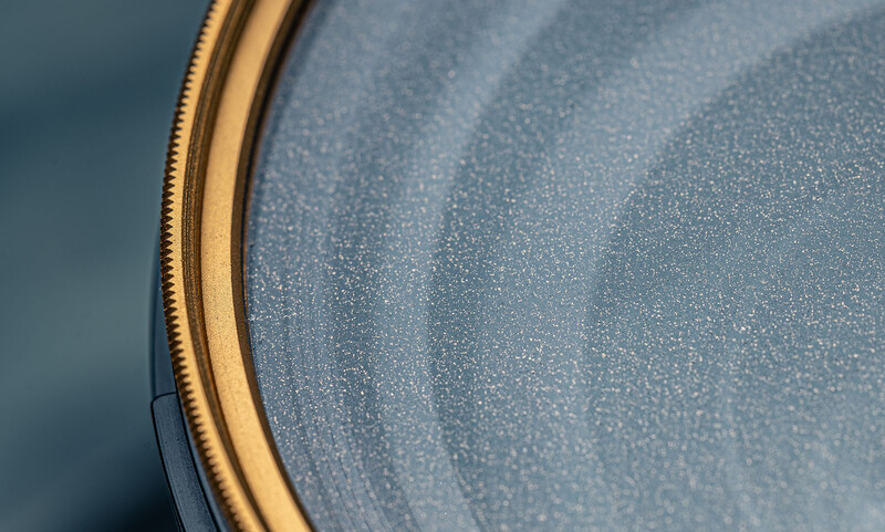 Close-up of a drum head with a gold-colored rim showing fine detail and texture.