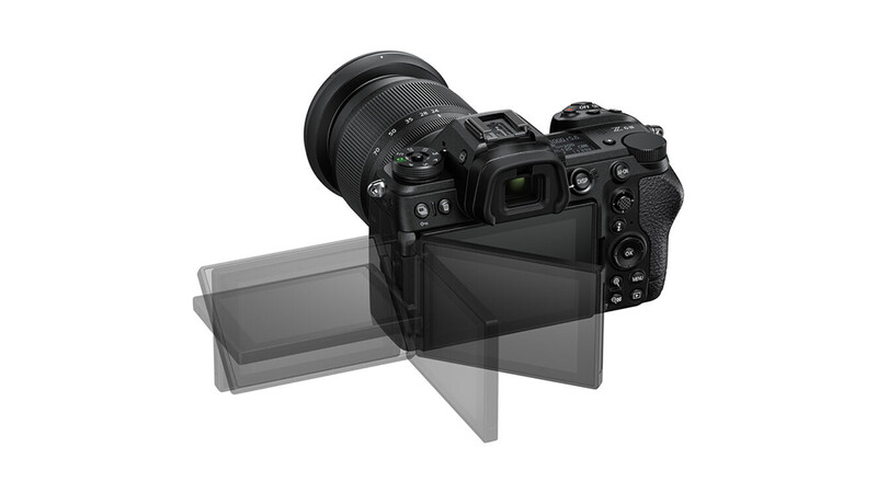 Mirrorless camera with articulating LCD screen extended and telephoto lens attached.