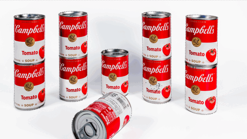 Campbell's tomato soup cans arranged in a product photography setup with studio lighting.