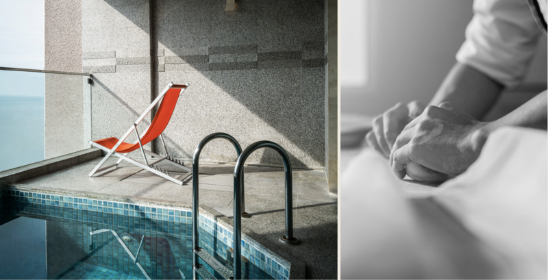 Red beach chair on concrete deck beside swimming pool with dark metal railing and geometric shadows.