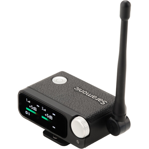 Compact wireless audio transmitter with external antenna and illuminated display panel.
