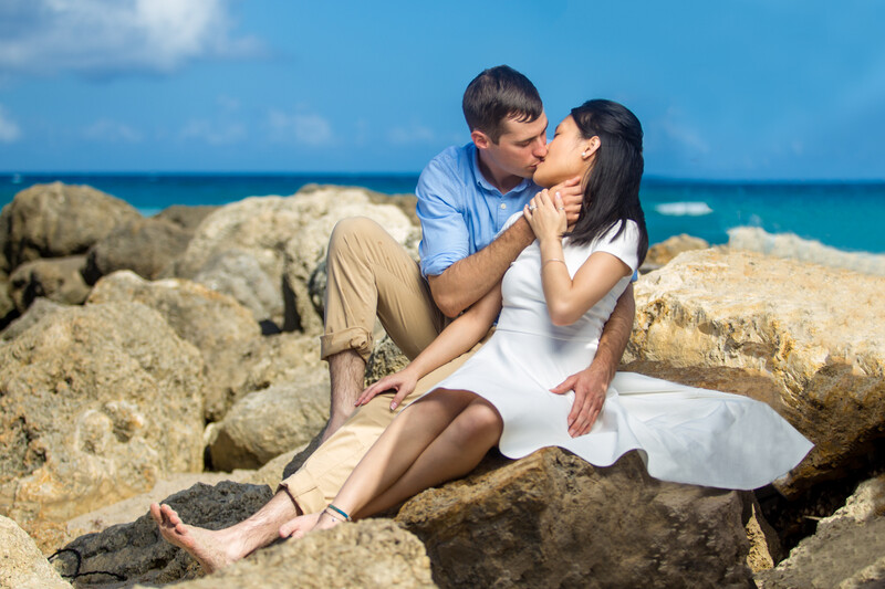 Photo example of a couple kissing on the rocks to show how to take photos in strong sunlight