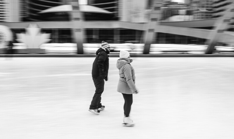 Two people jogging together on an urban plaza with motion blur in the background.