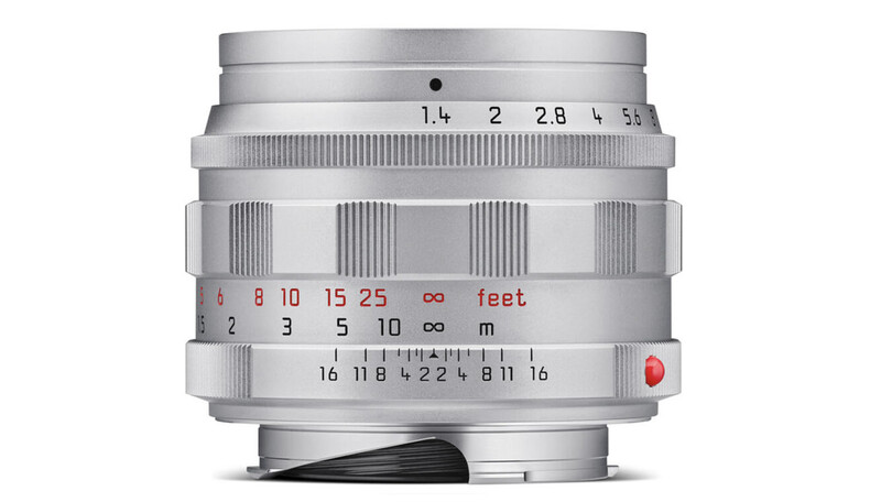 Close-up of a vintage rangefinder lens showing aperture, distance, and depth-of-field scales.