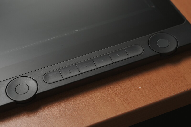 Close-up of a black tablet stylus or input device with button controls along its edge.
