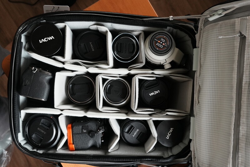 Camera equipment organized in a protective carrying case with foam inserts and compartments.