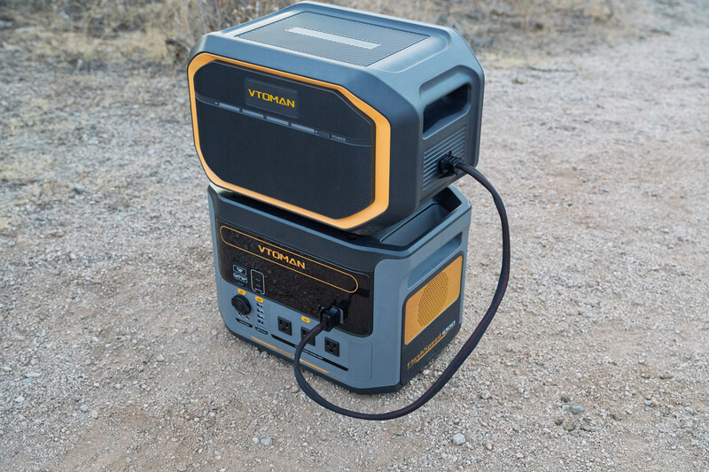 Portable power station with stacked battery module on concrete ground.