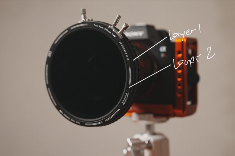 Close-up view of a variable neutral density filter mounted on camera lens, showing layer construction.