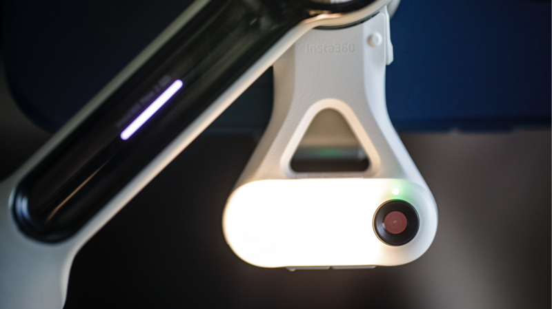 White LED ring light with integrated camera and diffuser panel mounted on articulating arm.