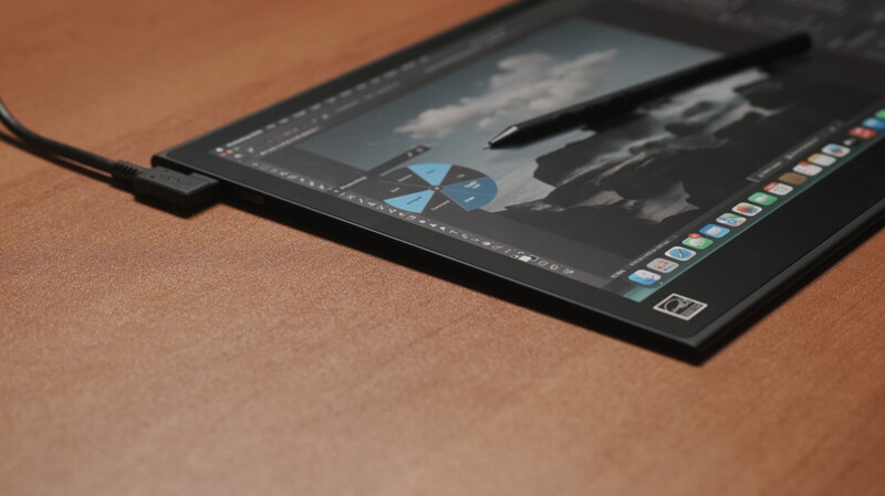 Screenshot of photo editing software displaying a landscape image with blue adjustment layers visible on a tablet with stylus.