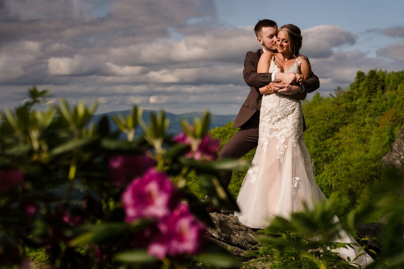 Newlyweds hug in a stacked pose for hard light portrait photography