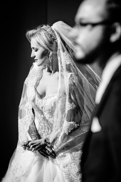 Bride and groom pose for hard light portraits in black and white
