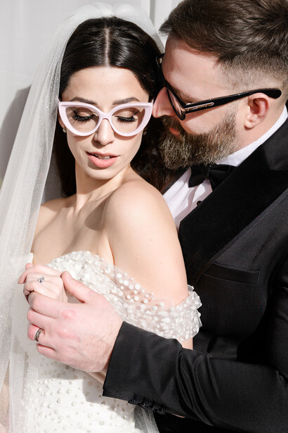 Bride and groom pose in hard light fashion style portrait