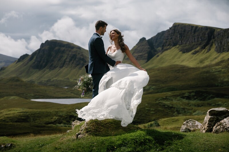 Bride twirls dress on rock with groom for hard light photography tips