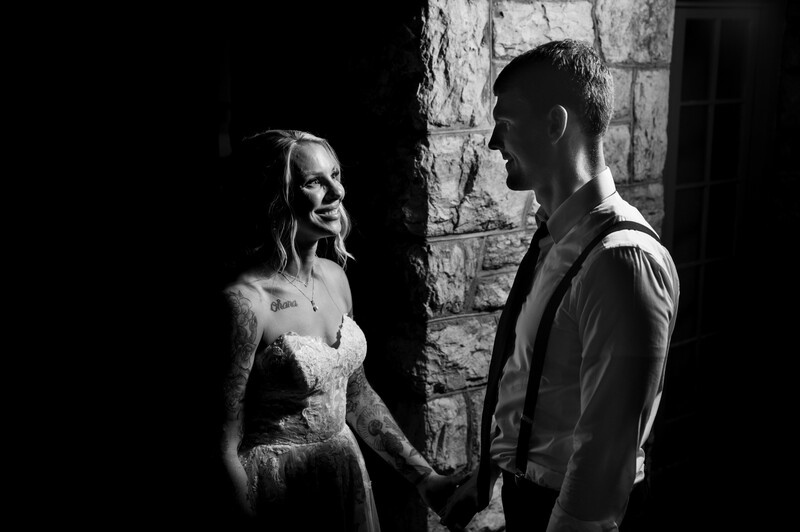 Bride and groom face one another in light and shadows