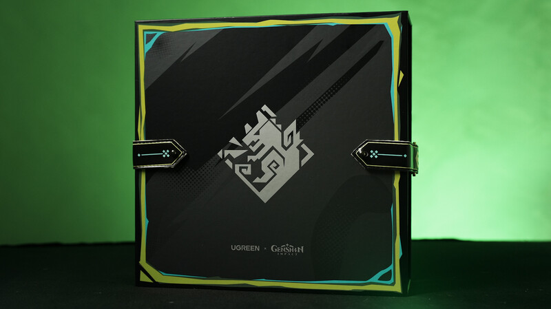 Ugreen and Genshin Impact collaboration product packaging with illuminated green border and cable connector graphics.