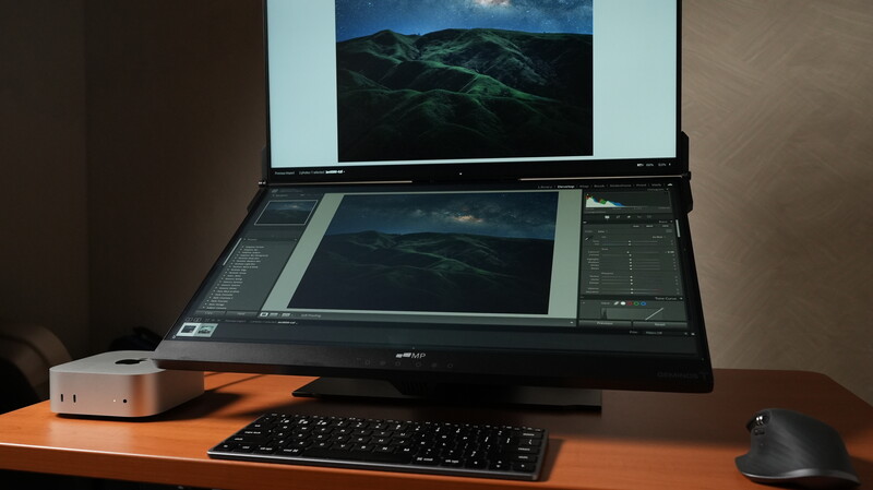 Photographer's dual-monitor workspace with landscape image editing software open on both screens.