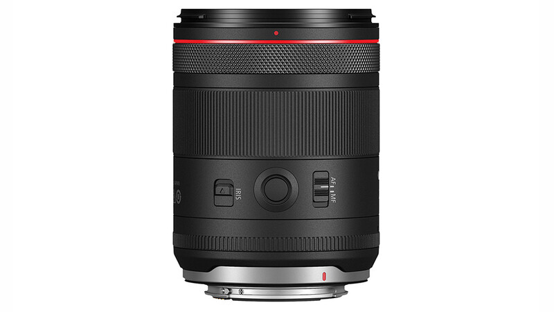 Canon RF-mount telephoto lens with red accent ring and manual control buttons on barrel.