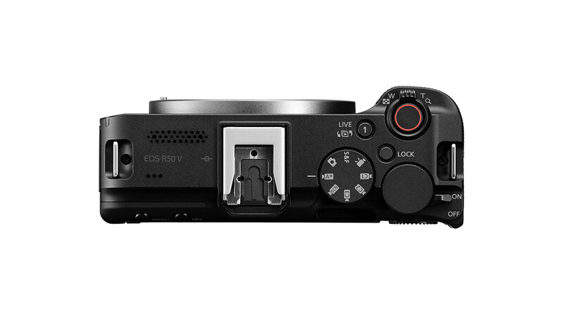 Top-down view of a mirrorless camera body showing control dial, hot shoe, and external buttons.