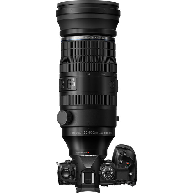 Top-down view of a telephoto zoom lens mounted on a mirrorless camera body with visible controls.