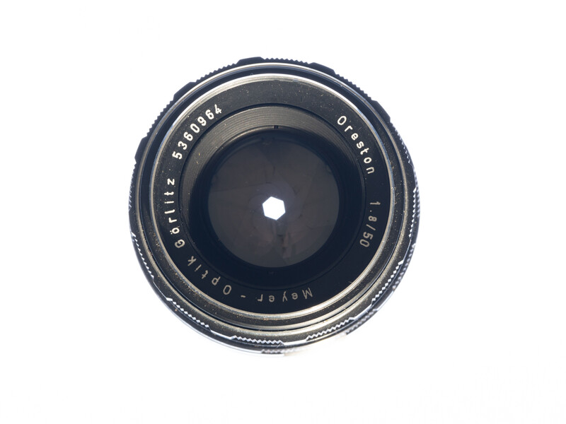 Vintage wide-angle lens with front element view showing aperture blades and focal length markings.