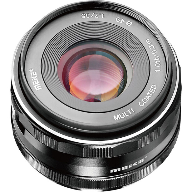 Wide-angle prime lens with pink-tinted glass elements visible through the front optics.