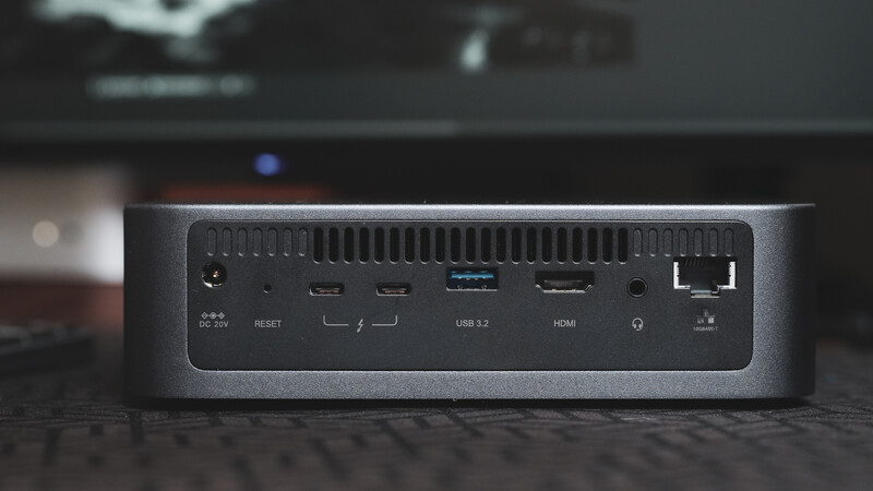 Compact desktop computer with ports visible on the rear panel including USB, HDMI, and Ethernet connections.
