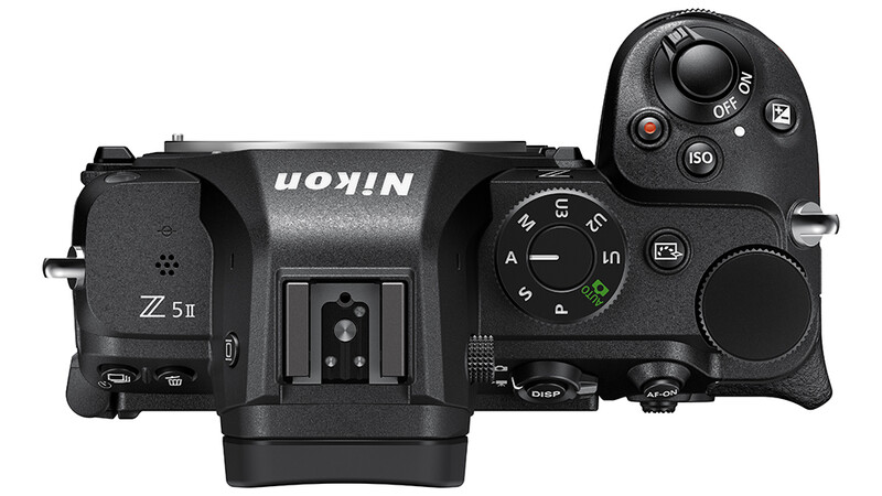 Top-down view of a mirrorless camera body with dual control dials and articulating screen.