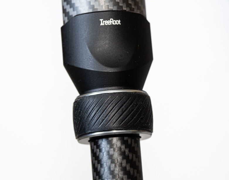 Close-up of a carbon fiber tripod leg with two black mounting rings or collars labeled Irishoot.