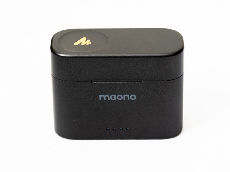 Maono compact wireless earbud charging case with rounded rectangular shape and LED battery indicators.