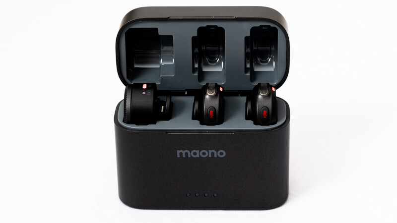 Maono charging case with three wireless microphones seated in individual slots.