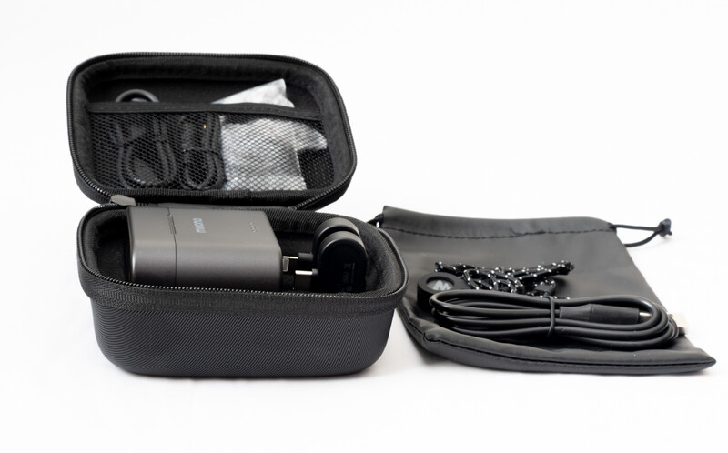 Black protective carrying case with organized compartments containing camera equipment and cables.