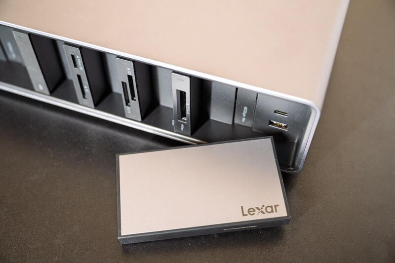 Lexar portable storage device displayed in front of its packaging showing multiple card slots.